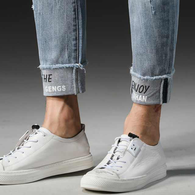 Thin stretch jeans for men in summer, light color, with holes in them Thin stretch jeans for men in summer, light color, with holes in them