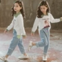 Cô gái mùa thu 2019 mới quần jeans Hàn Quốc hợp thời trang quần hai dây ống rộng quây điểm sóng - Quần jean quần jean lửng trẻ em