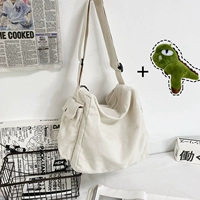 Белый карман на пуговицах с динозавром.