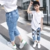 Cô gái lớn mặc mùa hè quần jean trẻ em Hàn Quốc phiên bản mới giản dị cô gái lưới đánh cá lỗ bảy điểm quần thủy triều