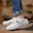 Giày vải thoáng khí mùa hè thấp để giúp nam sinh viên hoang dã đi giày với giày thông thường giày sneaker nam trắng