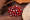 Single red glass bead